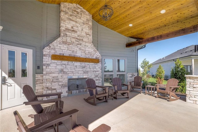 view of patio / terrace featuring an outdoor stone fireplace