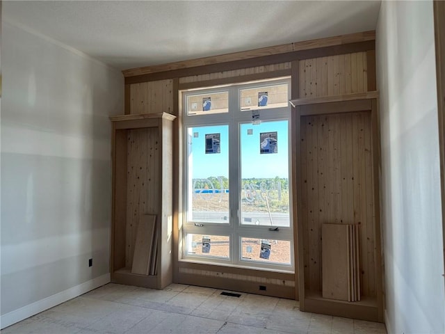 doorway to outside featuring wood walls