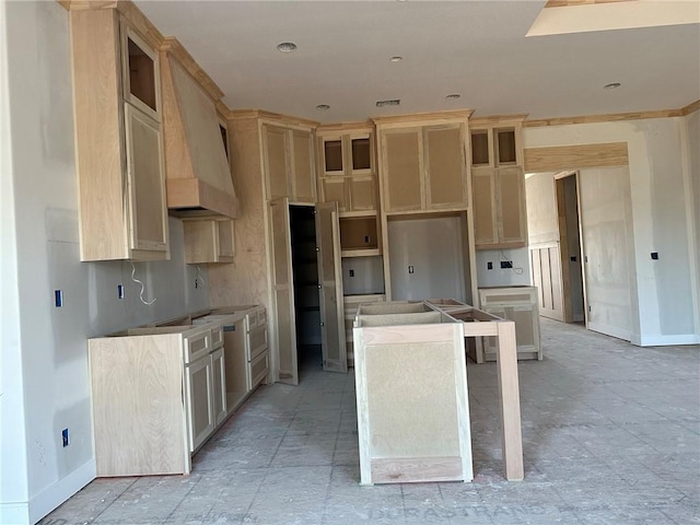 kitchen featuring light brown cabinets, a center island, and custom range hood