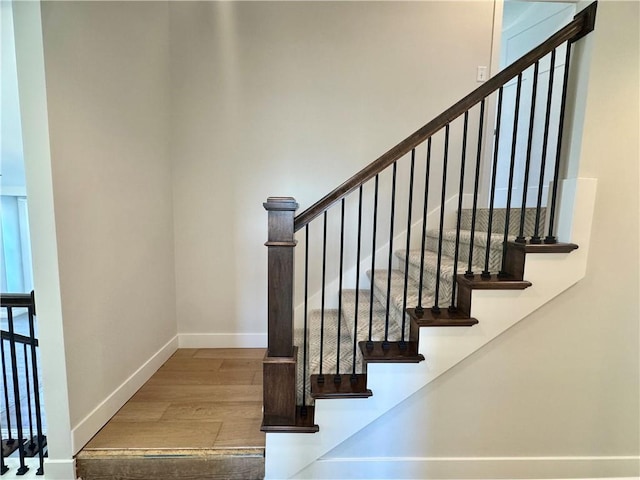 stairs featuring wood-type flooring