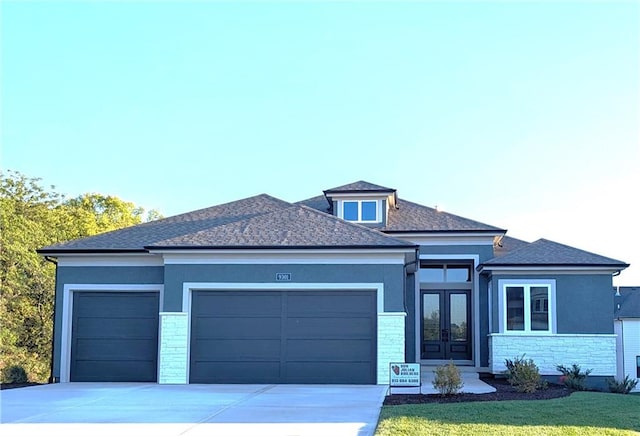 prairie-style house with a front yard and a garage