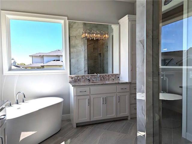 bathroom with vanity and a tub to relax in