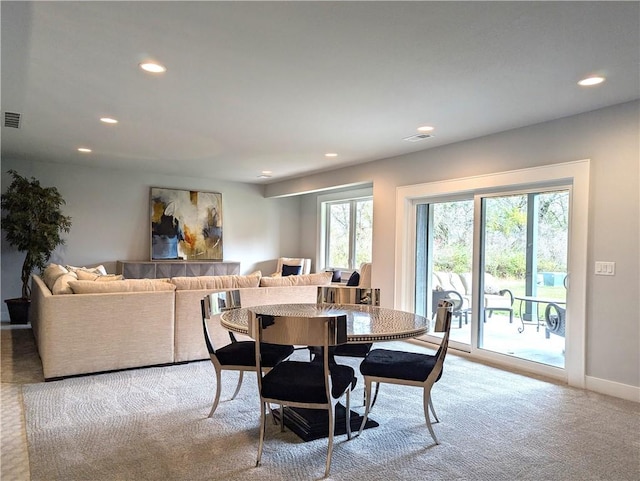 dining room featuring light carpet