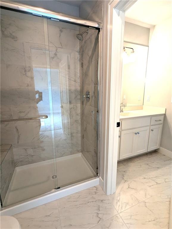 bathroom with a shower with door and vanity