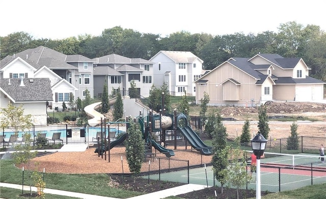 view of playground featuring a fenced in pool