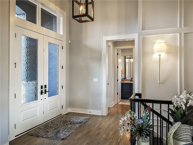 entryway with french doors, a high ceiling, and hardwood / wood-style floors