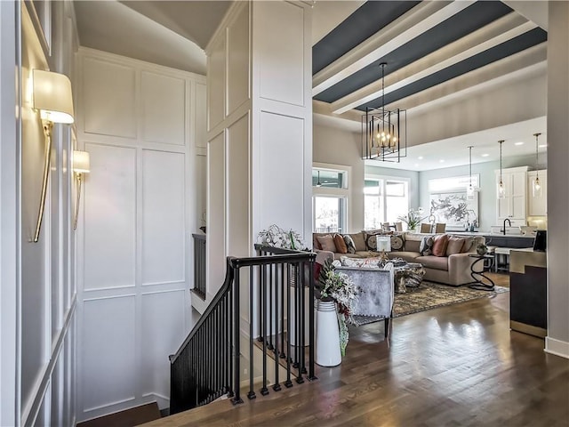 living room with a notable chandelier and dark hardwood / wood-style flooring