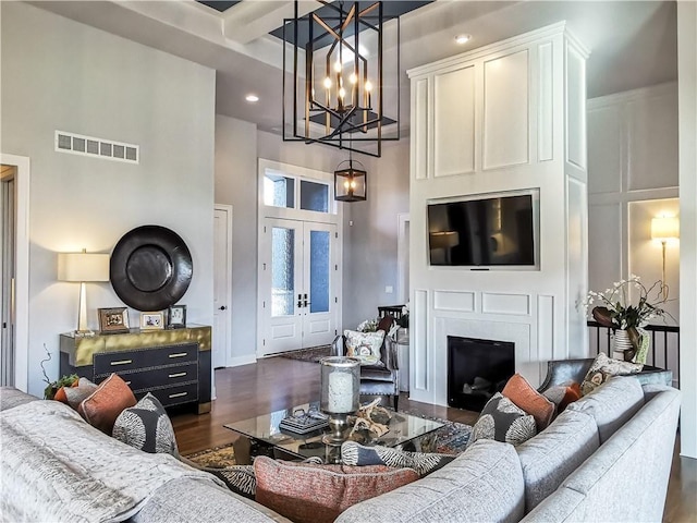 living room featuring a high ceiling and dark hardwood / wood-style flooring