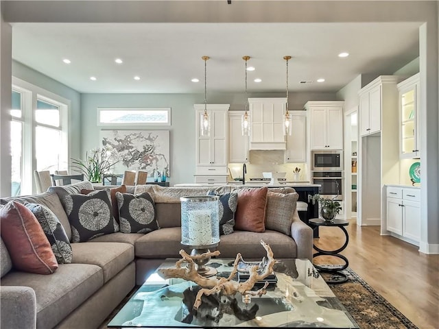 living room featuring hardwood / wood-style floors and sink