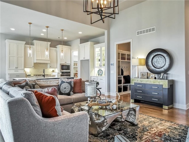 living room featuring a chandelier and dark hardwood / wood-style floors