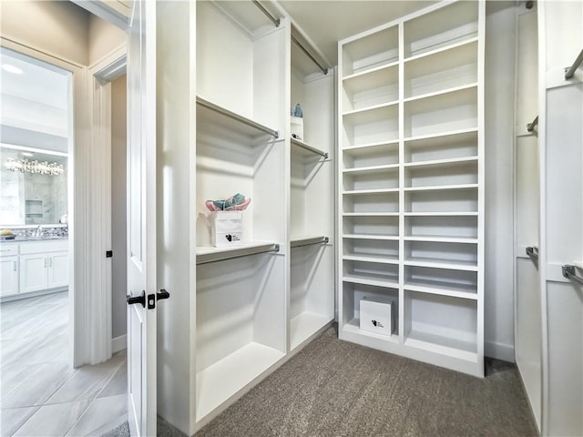 walk in closet featuring tile patterned floors and sink