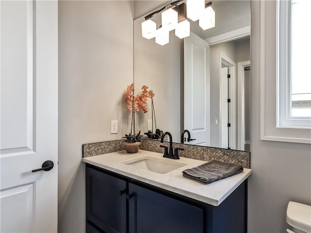 bathroom featuring toilet and vanity