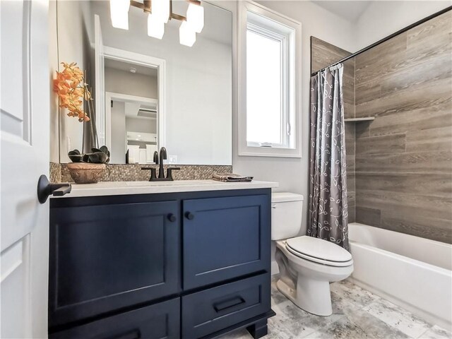 full bathroom with toilet, shower / bath combo with shower curtain, and vanity