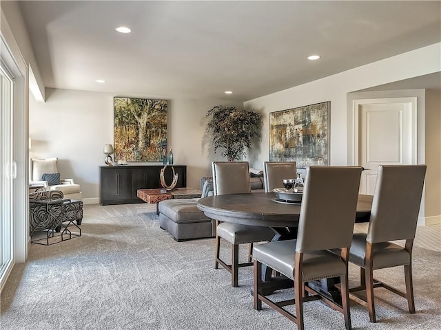 dining space featuring light colored carpet