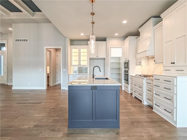 9301 W 168th St, Overland Park, KS 66085 - kitchen with a sink, stainless steel appliances, white cabinetry, baseboards, and hanging light fixtures