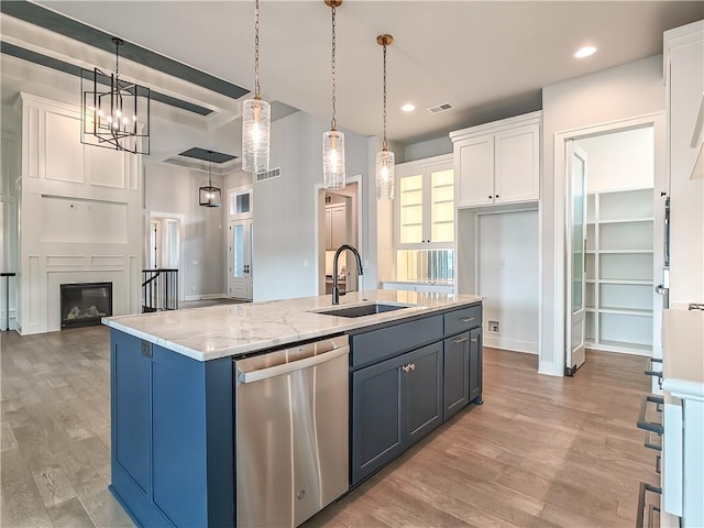 9301 W 168th St, Overland Park, KS 66085 - kitchen featuring stainless steel dishwasher, a sink, white cabinetry, an island with sink, and light wood-type flooring