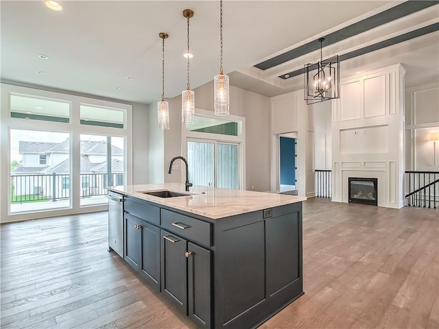 9301 W 168th St, Overland Park, KS 66085 - kitchen with a sink, light wood-style flooring, decorative light fixtures, a center island with sink, and recessed lighting
