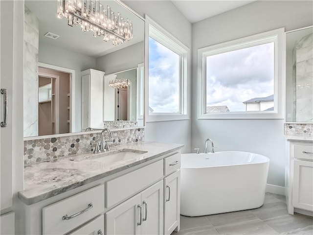 9301 W 168th St, Overland Park, KS 66085 - full bathroom with vanity, a soaking tub, backsplash, and a chandelier