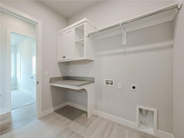 9301 W 168th St, Overland Park, KS 66085 - washroom with hookup for an electric dryer, hookup for a washing machine, cabinet space, baseboards, and light wood finished floors