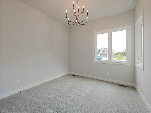 9301 W 168th St, Overland Park, KS 66085 - spare room featuring light colored carpet, a chandelier, and baseboards