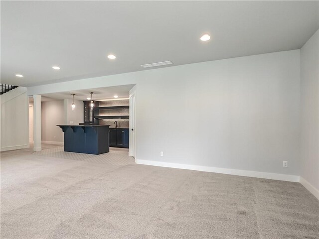 9301 W 168th St, Overland Park, KS 66085 - unfurnished living room with light carpet, baseboards, recessed lighting, and a sink