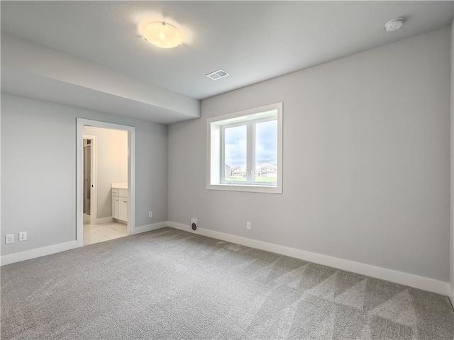 9301 W 168th St, Overland Park, KS 66085 - unfurnished bedroom featuring light carpet, baseboards, and ensuite bath