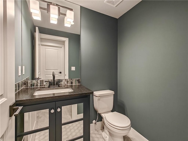 9301 W 168th St, Overland Park, KS 66085 - bathroom with toilet, vanity, and baseboards