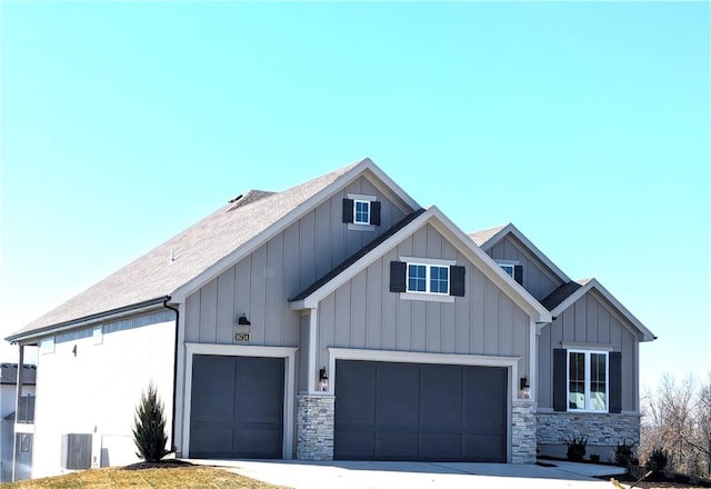 view of front of property with a garage and central AC unit