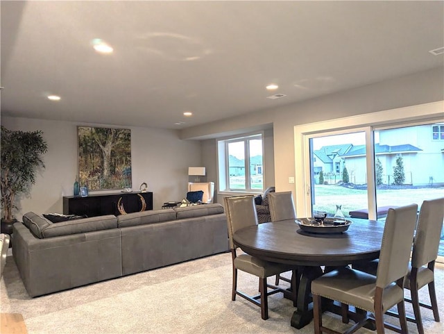 dining area featuring light carpet