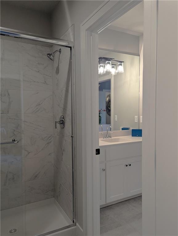 bathroom featuring vanity and a shower with door