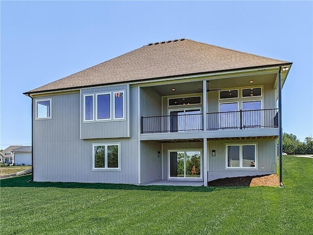 16724 Hayes St, Overland Park, KS 66085 - rear view of house with a balcony, a lawn, and roof with shingles