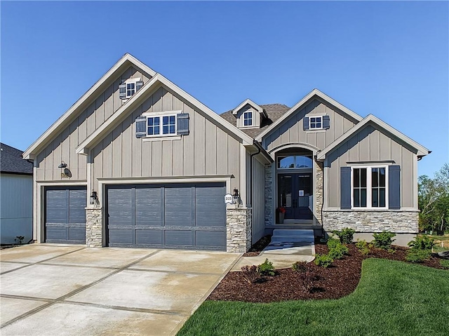 16724 Hayes St, Overland Park, KS 66085 - view of front facade featuring french doors, stone siding, concrete driveway, and board and batten siding