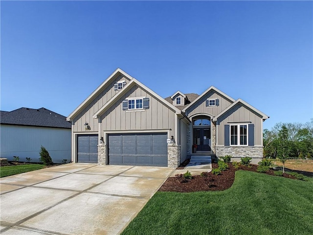 16724 Hayes St, Overland Park, KS 66085 - view of front of house featuring concrete driveway, stone siding, a front yard, and board and batten siding