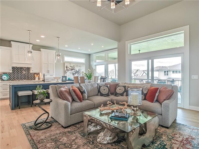 16724 Hayes St, Overland Park, KS 66085 - living area featuring light wood-style floors, healthy amount of natural light, a chandelier, and recessed lighting