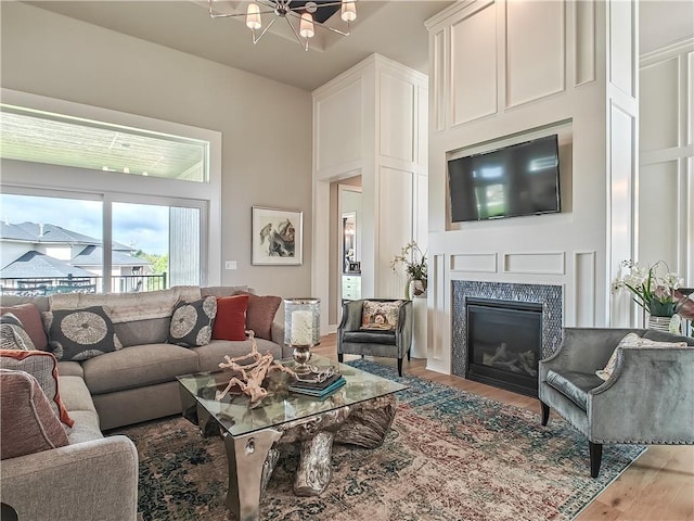 16724 Hayes St, Overland Park, KS 66085 - living room featuring light wood-type flooring, a glass covered fireplace, and a chandelier