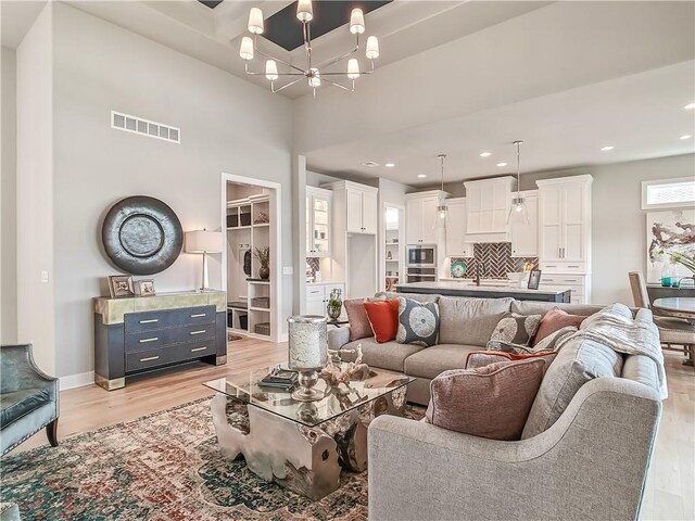 16724 Hayes St, Overland Park, KS 66085 - living area with a chandelier, light wood-style flooring, recessed lighting, and baseboards
