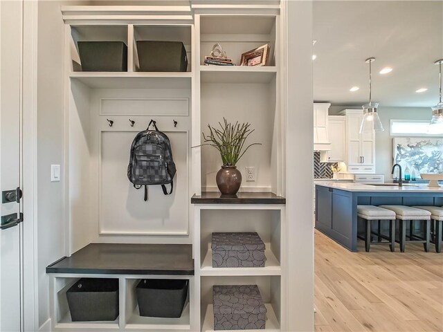 16724 Hayes St, Overland Park, KS 66085 - mudroom featuring light wood-style flooring, a sink, and recessed lighting