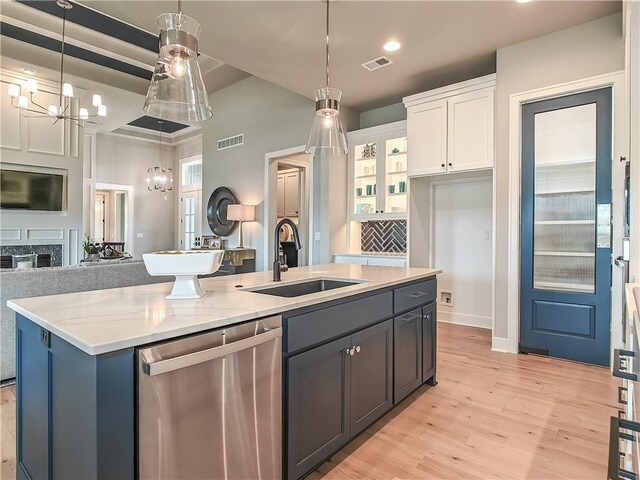 16724 Hayes St, Overland Park, KS 66085 - kitchen with dishwasher, a sink, white cabinetry, an island with sink, and a chandelier