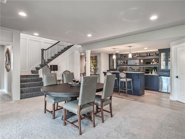 16724 Hayes St, Overland Park, KS 66085 - dining area featuring light carpet, stairs, and recessed lighting