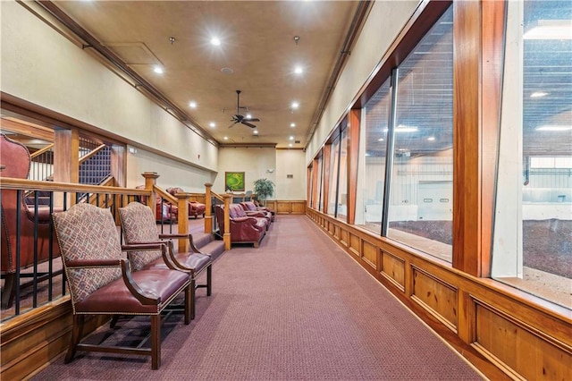 interior space with dark carpet, crown molding, and ceiling fan