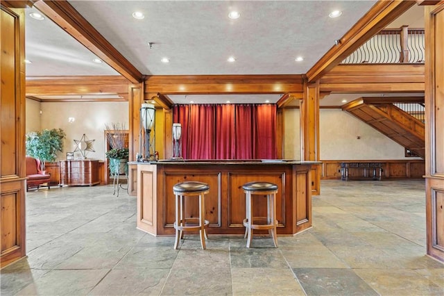 interior space featuring a kitchen bar and light tile flooring