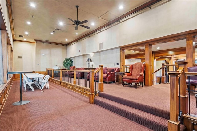 interior space with ceiling fan and carpet flooring