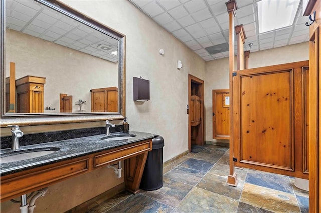 bathroom featuring tile flooring, dual bowl vanity, and a paneled ceiling