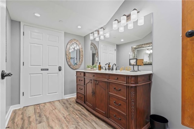 bathroom with vanity, lofted ceiling, and hardwood / wood-style floors