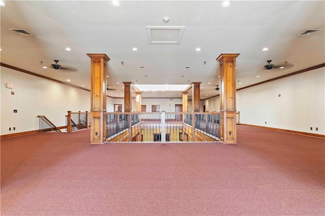 interior space featuring ceiling fan, carpet floors, and decorative columns