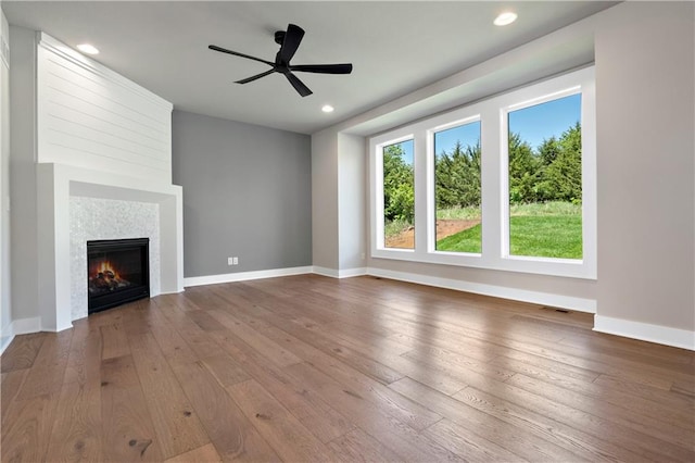 unfurnished living room featuring ceiling fan and dark wood-type flooring