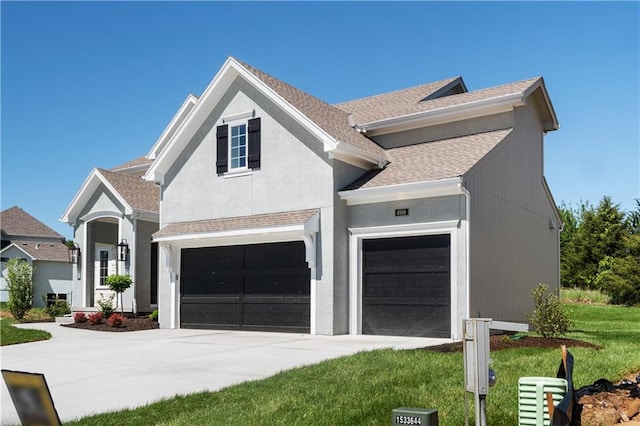 view of front of home with a garage and a front yard