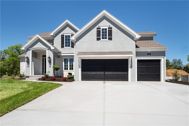 view of front of house featuring a garage and a front lawn