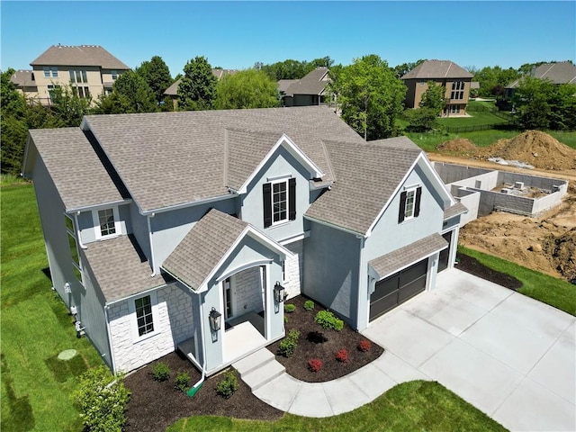 view of front of house featuring a garage and a front lawn