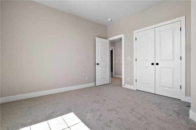 unfurnished bedroom with carpet and a closet